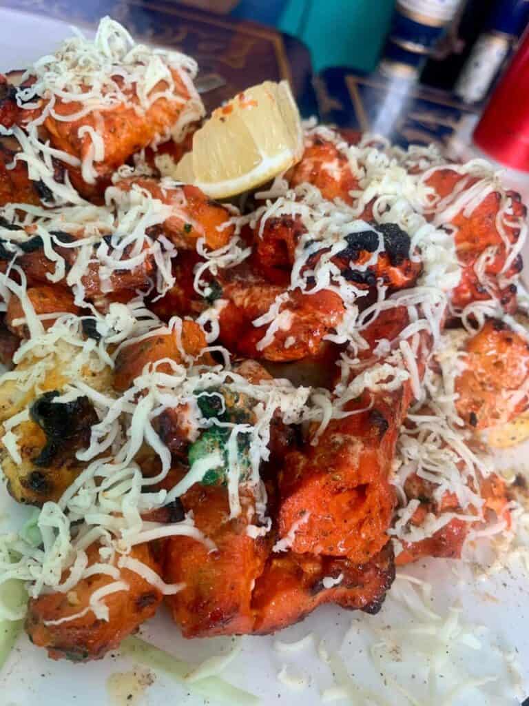 Chicken Tikka is a boneless version of Tandoori chicken added with cheese sauce on top.